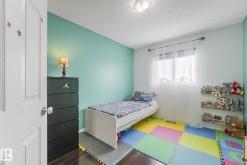 Bedroom featuring dark wood finished floors. Bright big windows giving lots of natural light. - 2348 28B Avenue, Edmonton, AB - Indoor Photo Showing Bedroom