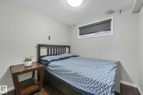 Bedroom featuring dark wood-style flooring and a textured ceiling - 2348 28B Avenue, Edmonton, AB - Indoor Photo Showing Bedroom