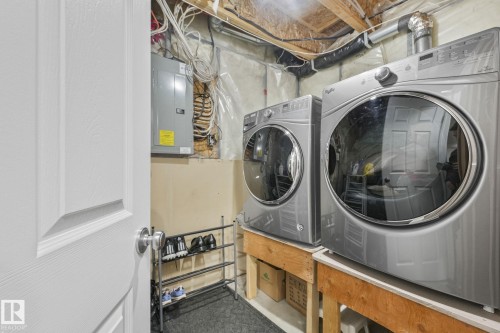 Laundry area featuring washer and clothes dryer and electric panel - 2348 28B Avenue, Edmonton, AB - Indoor Photo Showing Laundry Room