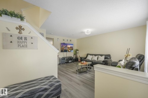Living room featuring a textured ceiling and light wood-style floors - 2348 28B Avenue, Edmonton, AB - Indoor