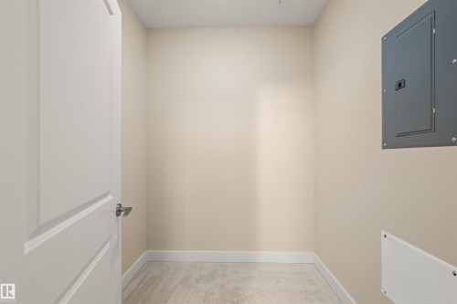 Spare room featuring electric panel and light colored carpet - 29 11518 76 Avenue, Edmonton, AB - Indoor Photo Showing Other Room