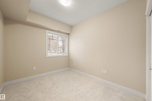 Empty room featuring light colored carpet and baseboards - 29 11518 76 Avenue, Edmonton, AB - Indoor Photo Showing Other Room