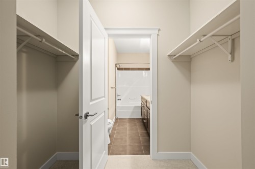 Walk in closet with dark tile patterned flooring - 29 11518 76 Avenue, Edmonton, AB - Indoor With Storage