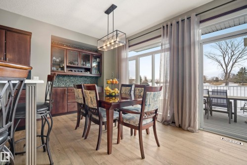 Dining room featuring light wood-style flooring and suspended lighting - 19 Rosemount Boulevard, Beaumont, AB - Indoor Photo Showing Dining Room