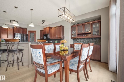 Dining room with light wood-type flooring and hanging lights - 19 Rosemount Boulevard, Beaumont, AB - Indoor Photo Showing Dining Room