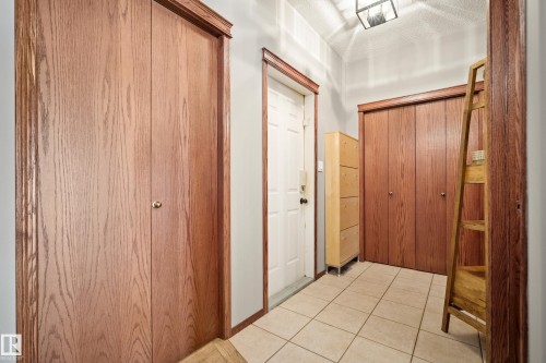 Corridor with light tile patterned flooring - 19 Rosemount Boulevard, Beaumont, AB - Indoor Photo Showing Other Room