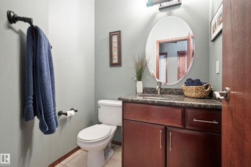 Half bathroom featuring vanity and light tile patterned floors - 19 Rosemount Boulevard, Beaumont, AB - Indoor Photo Showing Bathroom