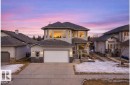 View of front of house featuring stone siding, concrete driveway, and a shingled roof - 19 Rosemount Boulevard, Beaumont, AB  - Outdoor With Facade 