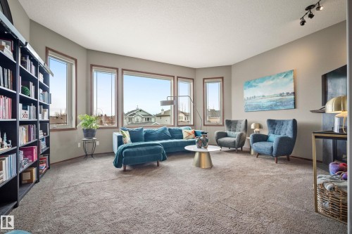 Sitting room with carpet flooring and a textured ceiling - 19 Rosemount Boulevard, Beaumont, AB - Indoor