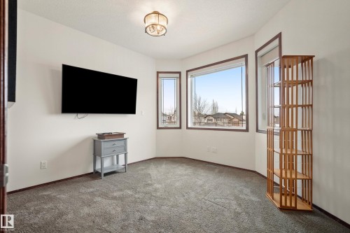 Unfurnished living room with carpet flooring and baseboards - 19 Rosemount Boulevard, Beaumont, AB - Indoor Photo Showing Other Room