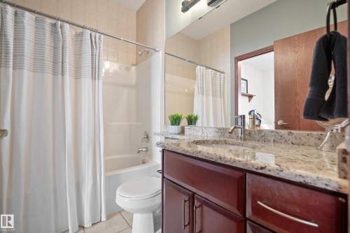 Full bathroom with vanity, light tile patterned flooring, and shower / bath combo with shower curtain - 19 Rosemount Boulevard, Beaumont, AB - Indoor Photo Showing Bathroom