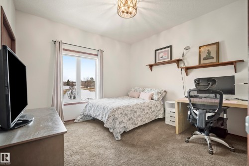 Bedroom featuring an office area and carpet floors - 19 Rosemount Boulevard, Beaumont, AB - Indoor