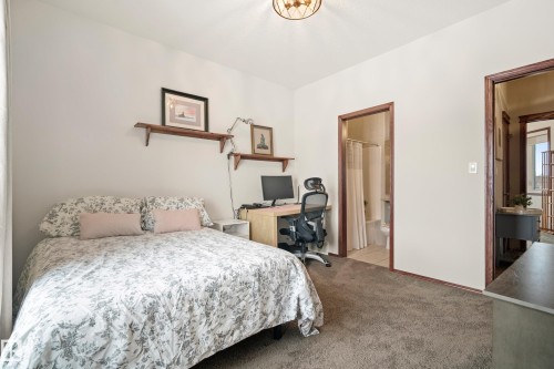 Bedroom with an office area, light colored carpet, and ensuite bath - 19 Rosemount Boulevard, Beaumont, AB - Indoor Photo Showing Bedroom
