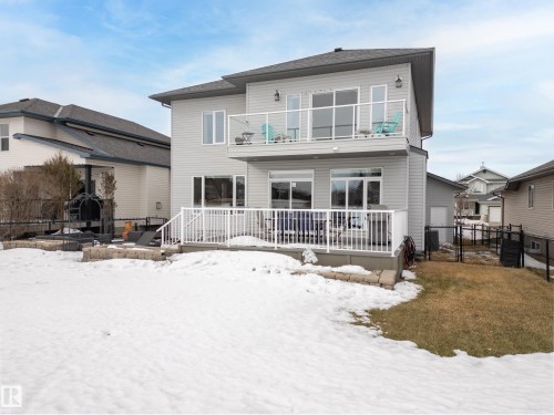 Snow covered rear of property featuring a deck, a gate, and a patio area - 19 Rosemount Boulevard, Beaumont, AB - Outdoor With Balcony