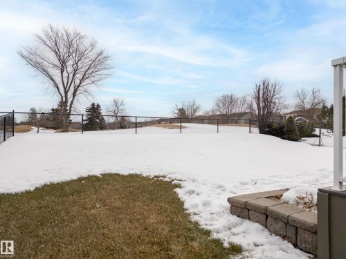 Snowy yard featuring a fenced backyard - 19 Rosemount Boulevard, Beaumont, AB - Outdoor With View
