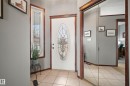 Foyer entrance featuring light tile patterned floors and baseboards - 19 Rosemount Boulevard, Beaumont, AB  - Indoor Photo Showing Other Room 