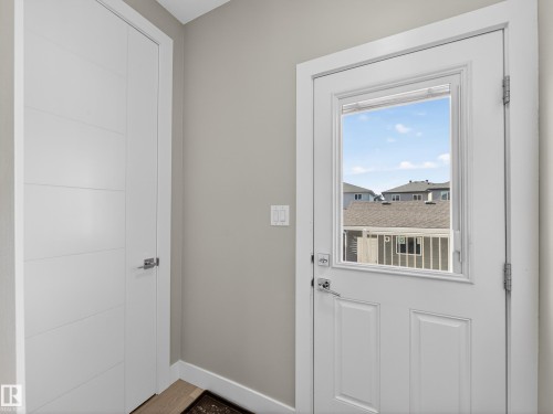 Doorway with baseboards and wood finished floors - 9358 Pear Link Link, Edmonton, AB - Indoor Photo Showing Other Room