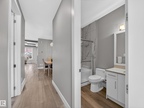 Corridor with light wood finished floors - 9358 Pear Link Link, Edmonton, AB - Indoor Photo Showing Bathroom