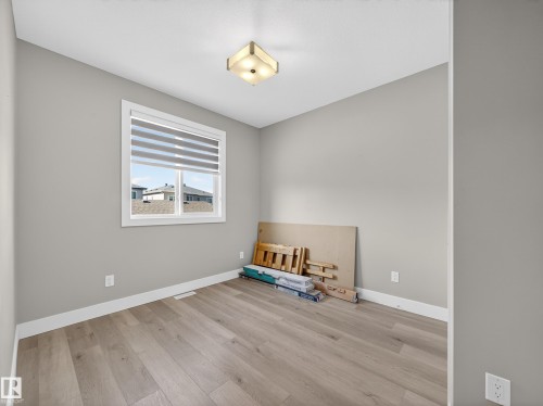 Empty room featuring light wood-type flooring and baseboards - 9358 Pear Link Link, Edmonton, AB - Indoor Photo Showing Other Room