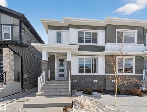 View of front of home with stone siding and covered porch - 9358 Pear Link Link, Edmonton, AB - Outdoor With Facade