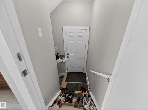 Doorway with vaulted ceiling and wood finished floors - 9358 Pear Link Link, Edmonton, AB - Indoor Photo Showing Other Room