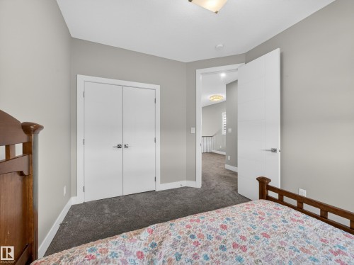 Bedroom with dark carpet and a closet - 9358 Pear Link Link, Edmonton, AB - Indoor Photo Showing Bedroom