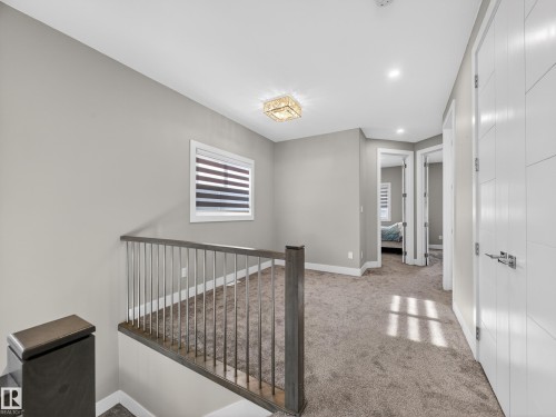 Corridor with light colored carpet and an upstairs landing - 9358 Pear Link Link, Edmonton, AB - Indoor Photo Showing Other Room