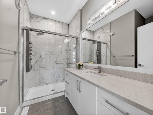Bathroom with vanity and a marble finish shower - 9358 Pear Link Link, Edmonton, AB - Indoor Photo Showing Bathroom