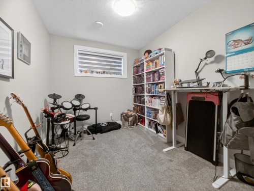 Misc room featuring light carpet and a textured ceiling - 9358 Pear Link Link, Edmonton, AB - Indoor