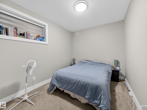 Bedroom featuring carpet flooring and a textured ceiling - 9358 Pear Link Link, Edmonton, AB - Indoor Photo Showing Bedroom