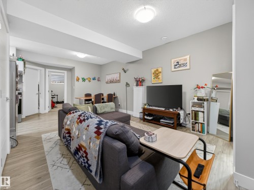 Living room featuring baseboards and light wood-style floors - 9358 Pear Link Link, Edmonton, AB - Indoor