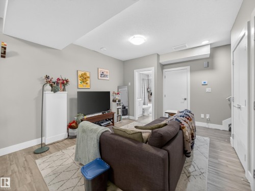 Living room with baseboards and light wood finished floors - 9358 Pear Link Link, Edmonton, AB - Indoor
