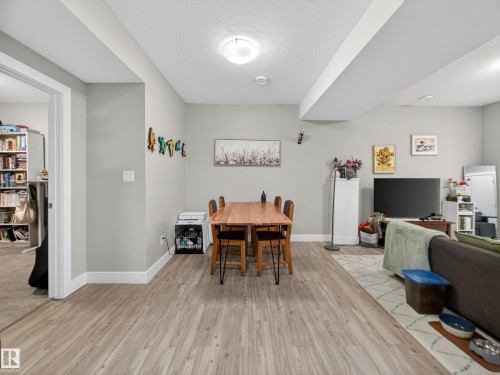 Dining area with light wood-type flooring and a textured ceiling - 9358 Pear Link Link, Edmonton, AB - Indoor