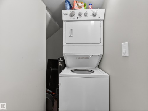 Laundry area with stacked washing machine and dryer - 9358 Pear Link Link, Edmonton, AB - Indoor Photo Showing Laundry Room