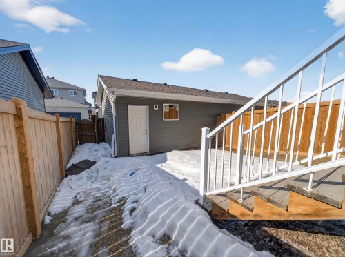 Snow covered house featuring a fenced backyard and a deck - 9358 Pear Link Link, Edmonton, AB - Outdoor With Exterior
