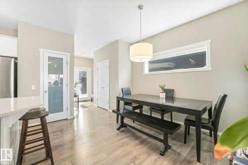 Dining room featuring light wood-style flooring and a textured ceiling - 97 James Cres, St. Albert, AB - Indoor Photo Showing Dining Room