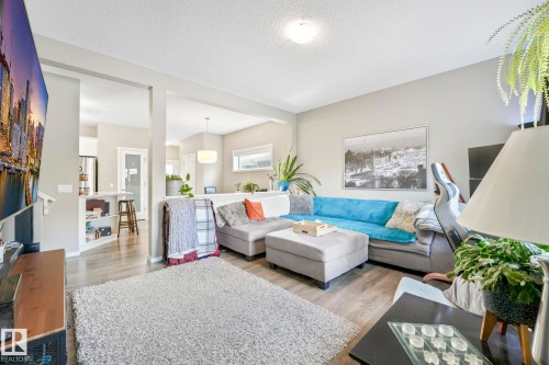Living area with light wood-type flooring and a textured ceiling - 97 James Cres, St. Albert, AB - Indoor Photo Showing Living Room