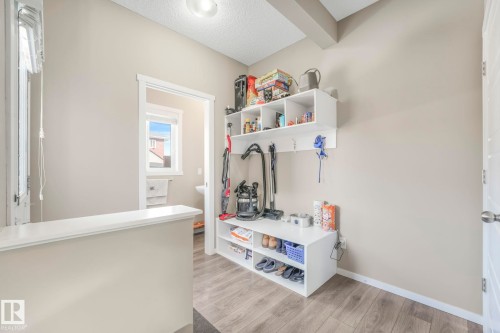 Mudroom featuring light wood-style floors and a textured ceiling - 97 James Cres, St. Albert, AB - Indoor Photo Showing Other Room