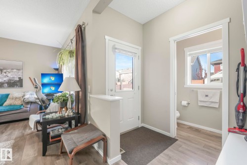 Sitting room featuring light wood-style flooring and a textured ceiling - 97 James Cres, St. Albert, AB - Indoor