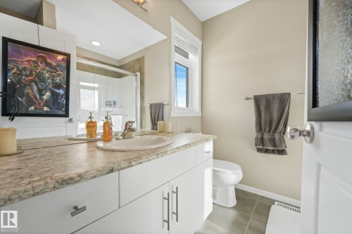 Bathroom with vanity, a shower stall, and dark tile patterned floors - 97 James Cres, St. Albert, AB - Indoor Photo Showing Bathroom