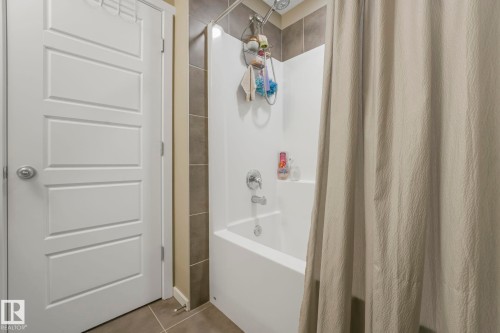 Bathroom featuring tile patterned floors and shower / bath combo with shower curtain - 97 James Cres, St. Albert, AB - Indoor Photo Showing Bathroom