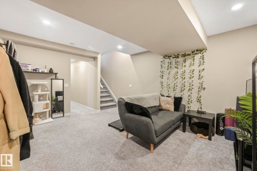 Living area featuring light colored carpet and recessed lighting - 97 James Cres, St. Albert, AB - Indoor
