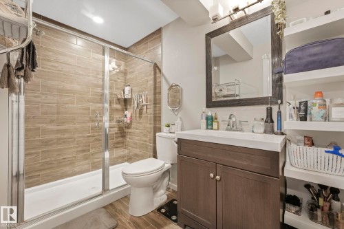 Bathroom featuring vanity, wood finish floors, and a stall shower - 97 James Cres, St. Albert, AB - Indoor Photo Showing Bathroom