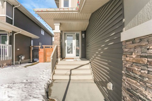 Doorway to property featuring stone siding and a gate - 97 James Cres, St. Albert, AB - Outdoor With Exterior