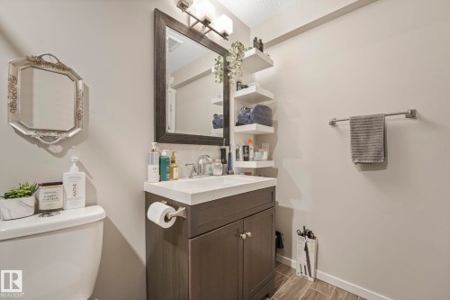 Half bathroom with vanity and wood tiled floors - 97 James Cres, St. Albert, AB - Indoor Photo Showing Bathroom