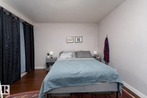 Bedroom featuring wood finished floors and baseboards - 7 10525 83 Avenue, Edmonton, AB - Indoor Photo Showing Bedroom