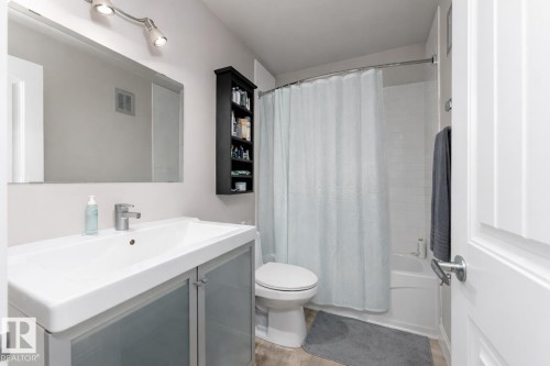 Full bathroom featuring vanity and shower / bath combination with curtain - 7 10525 83 Avenue, Edmonton, AB - Indoor Photo Showing Bathroom