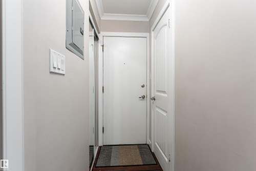 Entryway featuring crown molding and electric panel - 7 10525 83 Avenue, Edmonton, AB - Indoor Photo Showing Other Room