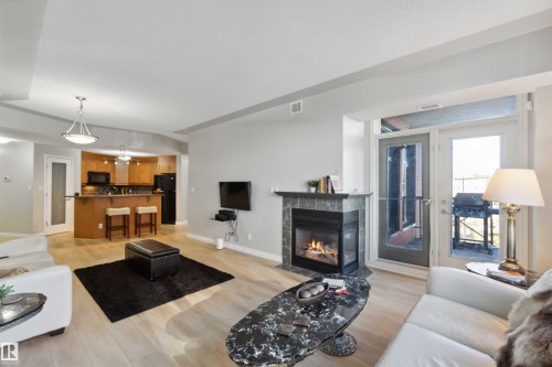 402 9020 Jasper Avenue, Edmonton, AB - Indoor Photo Showing Living Room With Fireplace