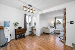 Entryway with a textured ceiling, hardwood / wood-style floors, and healthy amount of natural light - 